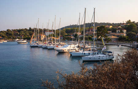 KASTOS island, GREECE-August,2019: Port of Kastos island with moored yachts, sailboats, boats -...