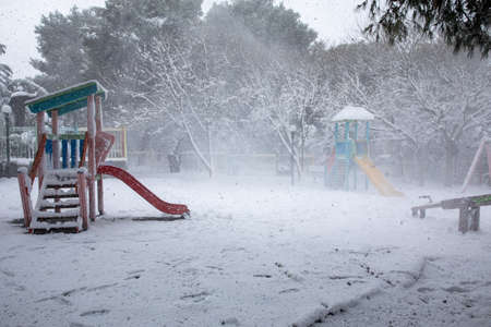 Winter morning snow covered children playgroundの写真素材