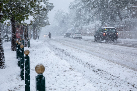 Dangerous driving in a snowstorm through the snowy streets of the Athens city, Greece, 16th of...