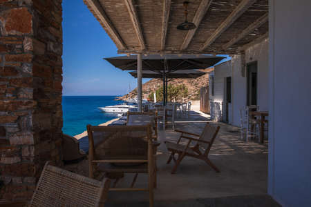 Beautiful view from the tavern to the Kolona double sided beach at Kythnos, Greece in the morning at the beginning of the tourist season, June 2021.の写真素材
