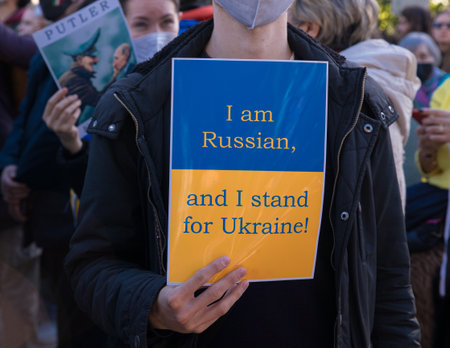 ATHENS, GREECE - February 27th, 2022:Anti-war protest in support of Ukraine on Syntagma Square in Athens. Demonstrator holds a poster I am Russian, and I stand for UKRAINE. close-up.のeditorial素材