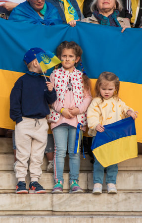 SYNTAGMA SQUARE, ATHENS, GREECE - April 3rd, 2022: Ukrainian children at a peaceful protest against the WAR in UKRAINE. Little Ukrainian patriots support their country. vertical.のeditorial素材