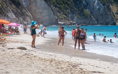 PETANI beach, Greece - July 21, 2020: Tourists take pictures on the Petani beach, Kefalonia island, Ionian sea, Greece.のeditorial素材