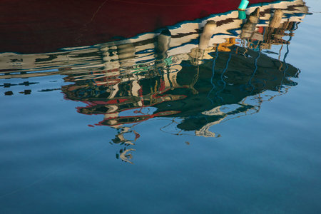 Colors reflection of fishing boat on the sea surface. Abstact background.の写真素材
