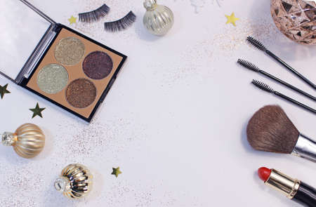 Flat lay composition with makeup products and Christmas decor on white background. Template for design, Top view Flat Lay Copy space.の写真素材