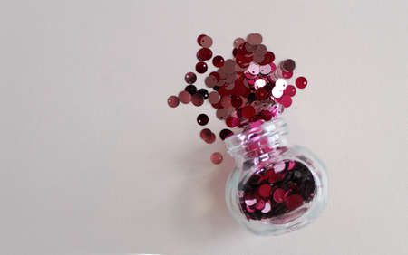 colored confetti falling out of glass bottle, material for diy or holiday decorの写真素材