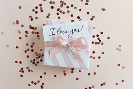 Valentines Day banner. White gift box with ribbon on background decorated shaped confetti. Flat lay, top view. Love and romance concept.の写真素材