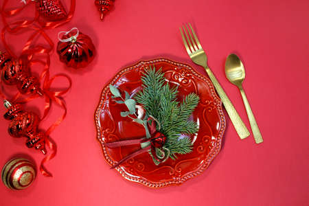 Beautiful Christmas table setting on red background with space for textの写真素材