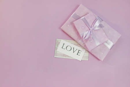 Background with gift with free space for text on pastel background. Valentines day concept. Mothers Day concept. Greetings. Copy space. Flat lay, top view.の写真素材
