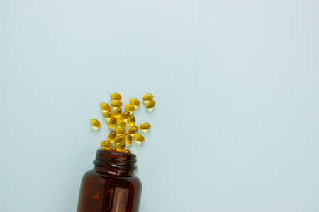 Yellow omega 3 capsule pattern. Different gold pills. Medical horizontal banner. Cosmetology wallpaper. Medicine vitamin.の写真素材
