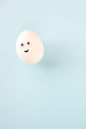 Easter eggs creative flat lay on blue background. Minimal concept.の写真素材
