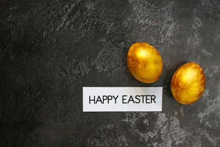 Stylish golden eggs easter concept. Flat lay trendy easter. Happy easter card. Copy space for textの写真素材