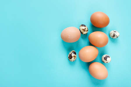 Happy Easter flat lay composition. Easter eggs decorated feathers on background. Flat lay, top view. Copy space.の写真素材