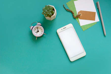 Flat lay top view office desk. Workspace office supplies on blue background. mock up smartphone....