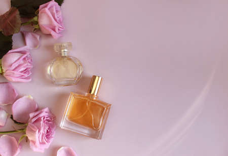 Flat lay composition with elegant perfumes on pink backgroundの写真素材