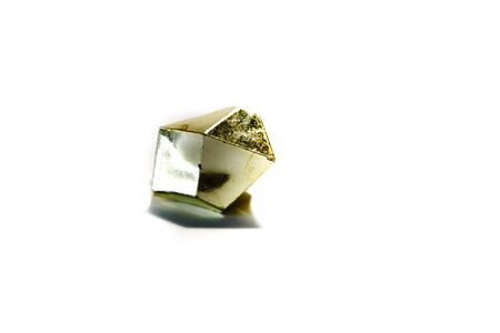 Golden stone on a white isolated background. The stone is lit from above with a backlight.の写真素材