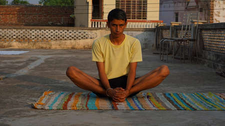 young man doing yoga in the morning.