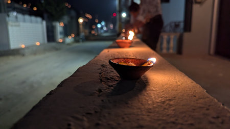 Bowl of oil lamp on the floor at night in a templeの写真素材