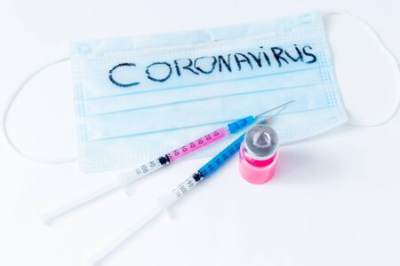 On a white background are two insulin syringes filled with a medical drug, and next to it is an ampoule with a medicine for injection from the disease. Place for text. Coronavirus.の写真素材