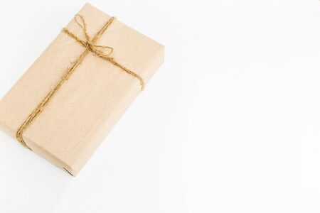gift box with natural paper lies on a white background. place for text. holiday conceptの写真素材