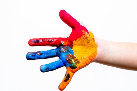 Hand of a child in multi-colored paint on a white background. A place for a label. A stand-alone subject.の写真素材
