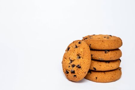 homemade cookies with pieces of chocolate for breakfast lie on a white isolated background....