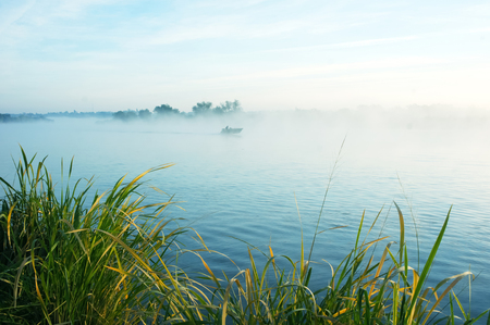 morning fishing on a misty lakeの写真素材