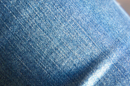 Torn jeans on the legs close-up, denimの写真素材