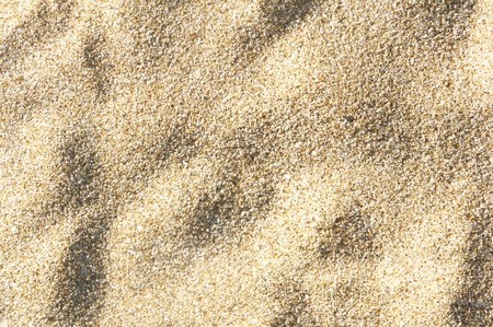 sea sand background texture, top view, shadow on the sandの写真素材