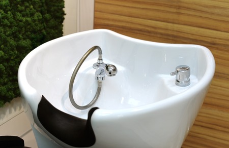 wash basin for washing the head. haircut procedure. washing in the beauty salon.の写真素材