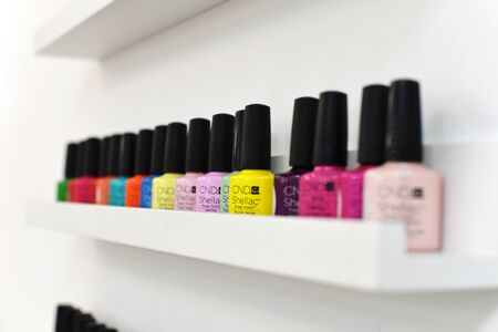 gel for nails polishes bottles, are in the window of the manicurist. Nail polishes are on the shelf....