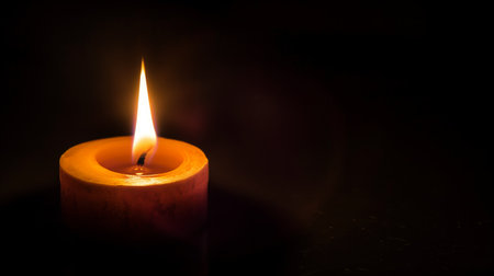 Burning candle on dark background. Day of Remembrance. Witchcraft. Black magic ritual.の写真素材