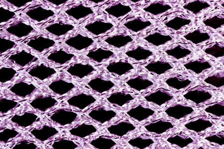 Texture of pink acrylic fabric in mesh close-up.の写真素材