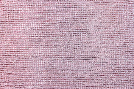 Pink background of shiny fabric close-up.の写真素材