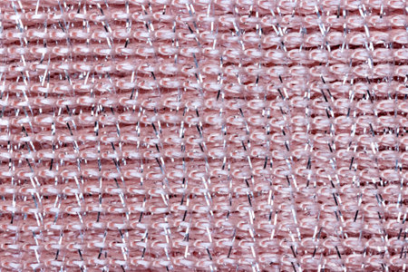 Background texture in pink shiny fabric close-up.の写真素材
