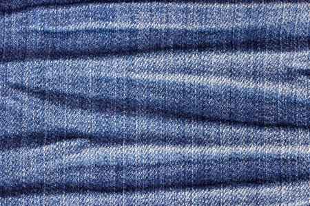 Creased denim texture for background.の写真素材