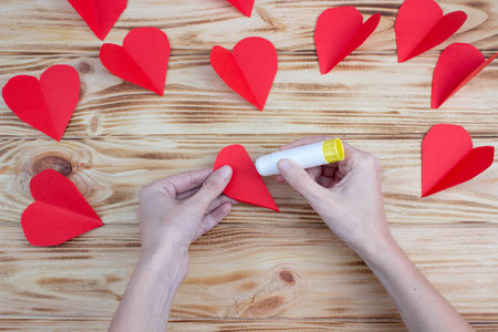 Craft paper heart in the palms for Valentine's Day. step by step instruction. DIY gift.の写真素材