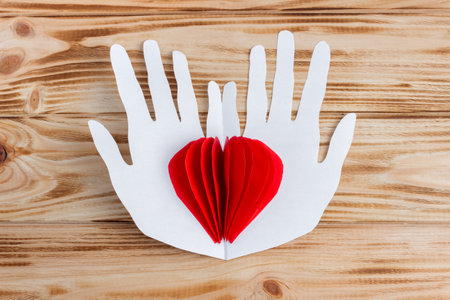 Craft paper heart in the palms for Valentine's Day. step by step instructions. DIY gift. final result.の写真素材