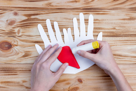 Craft paper heart in the palms for Valentine's Day. step by step instruction. DIY gift.の写真素材