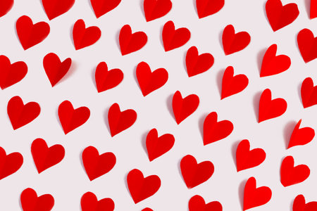 Pattern from paper red hearts on a white background. Valentine's day concept. flat lay.の写真素材