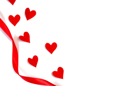 Red hearts with a ribbon on a white background. Flat lay, top view. copyspace. Valentine's day concept.の写真素材