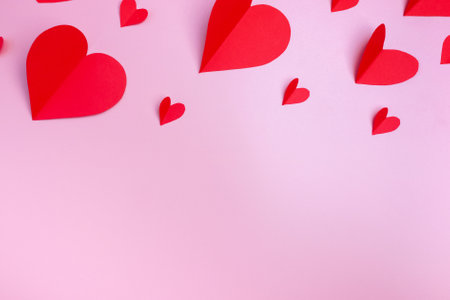 Red hearts on a pink background. Flat layout, top view. copyspace. Valentine's day concept.の写真素材