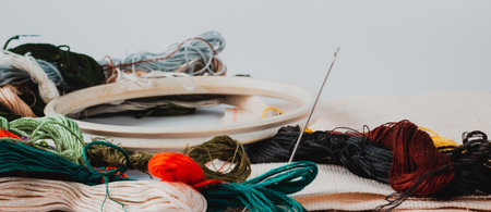 Accessories for embroidery: hoop, moulin, canvas and needle. The concept of needlework. side view.の写真素材