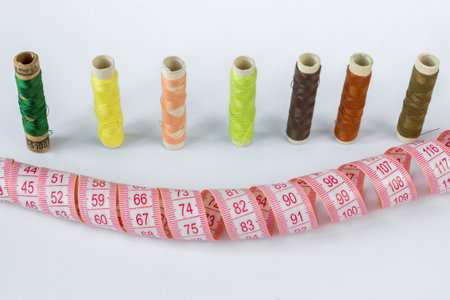 Santimet and coils of multicolored threads on a white background. Needlework concept.の写真素材