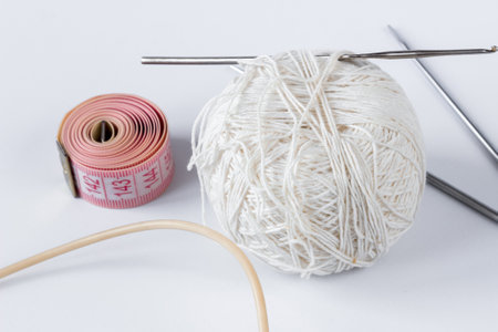 White tangle of threads with spokes and a centimeter on a white background. Needlework concept.の写真素材