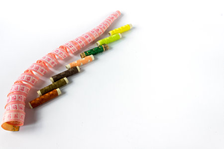 Santimet and coils of multicolored threads on a white background. space for text. Needlework concept.の写真素材