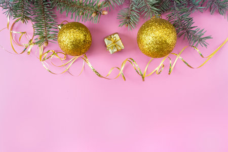 Christmas and New Year's layout on pink background. Postcard with a fir branch and toys. top view. flat lay. copyspace.の写真素材