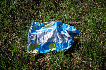 Discarded packaging from chips. The concept of environmental pollution with garbage and household waste disposal.の写真素材