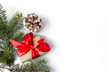 Gift boxes with red bows, pine cones and fir branches on a white background. copyspace. flat lay. top view. Christmas and New Year concept.の写真素材