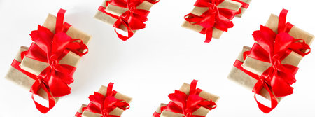Holiday gift boxes with red ribbons on a white background. Concept for New Year, Valentine's Day. Postcard, invitation, banner. view from above.の写真素材